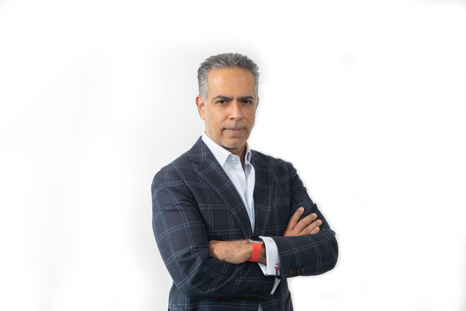 Black and white portrait of a dance instructor against a light background.